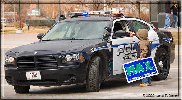 Max Baucus supporter gives candy to Kalispell cop. Copyright 2008, James R. Conner.